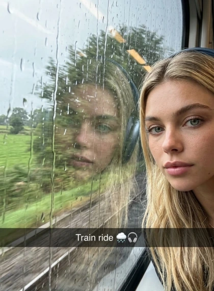 Improvised shot in the train: window with landscape behind the glass, reflection of a face with headphones, shaking c...