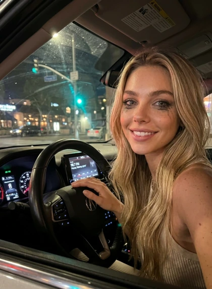 Selfie in the car at a traffic light: reflection in the windshield, radio playing, fingers drumming on the steering w...